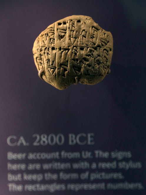 In this April 26, 2018 photo, a beer account from Ur, circa 2800 BCE, hangs at the Middle East gallery in the Penn Museum in Philadelphia. The University of Pennsylvania Museum of Archaeology and Anthropology is in the midst of dramatic renovations, opening new galleries to showcase previously undisplayed items, telling the stories of those artifacts in more relatable ways and adding guides native to the parts of the world being showcased.