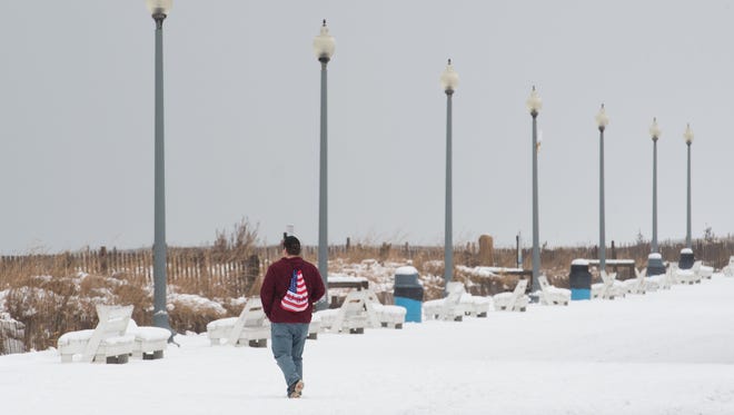 A visitor walks on the snow covered boardwalk at Rehoboth Beach.