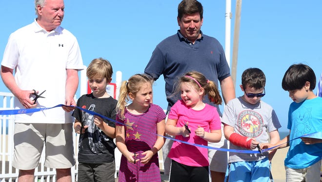 Kids join the Ocean City Mayor and Town Council for the ribbon cutting ceremony on Monday, May 1,2017 to formally open Maryland's first Boardwalk Playground.