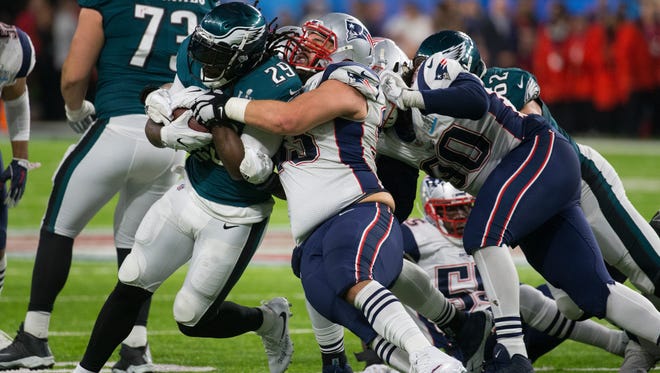 Eagles running back LeGarrette Blount fights his way through the Patriots defense Sunday at US Bank Stadium