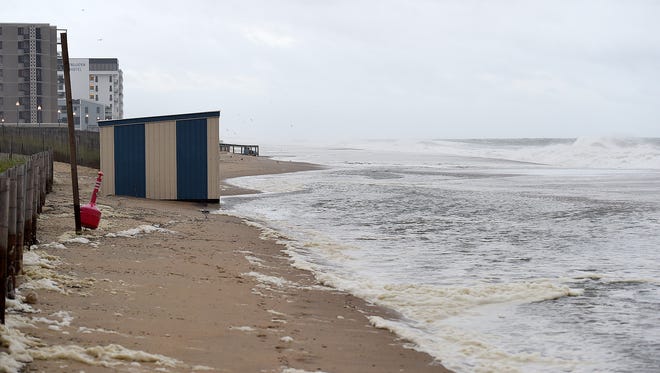 Tuesday morning high tide at Rehoboth Beach brought water covering sand with 6-8 foot waves pounding the shoreline. Wind and rain were minimal as the storm starts to pass the Delaware coast.