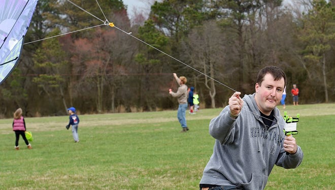 John Hilmer from Delaware City runs with his kite to get air, despite cloudy and rainy weather, the 48th Annual Kite Festival was held on Friday March 25th at Cape Henlopen State Park near Lewes with a good crowd on hand flying all kinds of kites and creations.