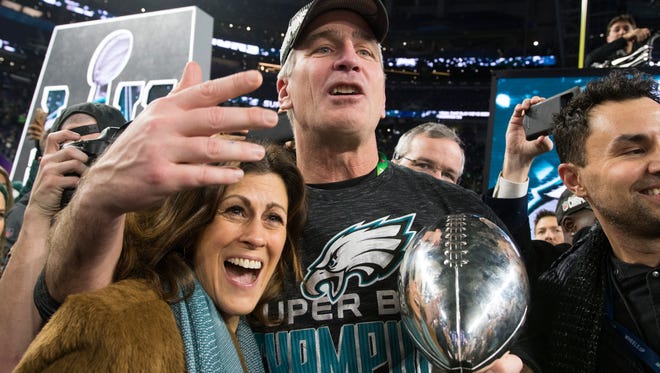 Eagles offensive coodinator Frank Reich holds the Vince Lombardi Trophy after winning Super Bowl LII Sunday at US Bank Stadium.