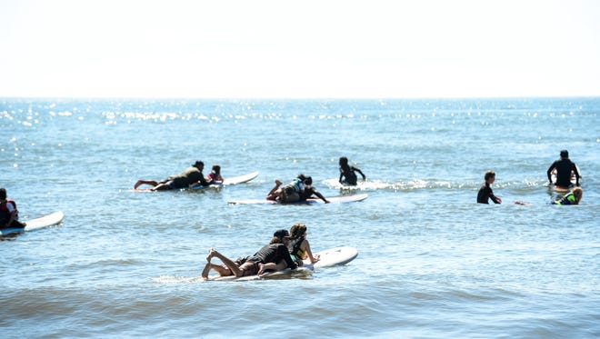 Volunteer surfers help out with the Surfers Healing tour to help people living with autism by exposing them to a surfing experience in Ocean City. on August 17, 2016.