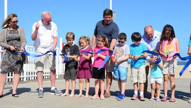 Kids join the Ocean City Mayor and Town Council for the ribbon cutting ceremony on Monday, May 1,2017 to formally open Maryland's first Boardwalk Playground.