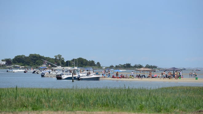 Many boaters and beach goers take advantage of the holiday week to relax on a sand bar in the Assawoman Bay in Ocean City, Md. on July 3, 2017.