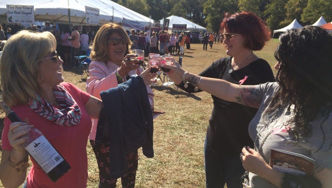 (From left) Friends Kary Oppel, Rocki Kelly, Tracey Fulton and Lisa Shockley toast to the beautiful weather and fun times at the Autumn Wine Festival in Pemberton Park.