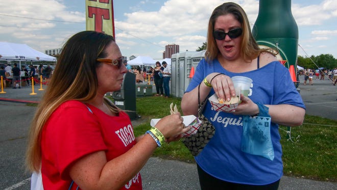 Kristy Duhadaway and Kristen Macastein sample tacos at the first Delaware Taco Festival at Frawley Stadium in Wilmington on Saturday, June 25, 2016.
