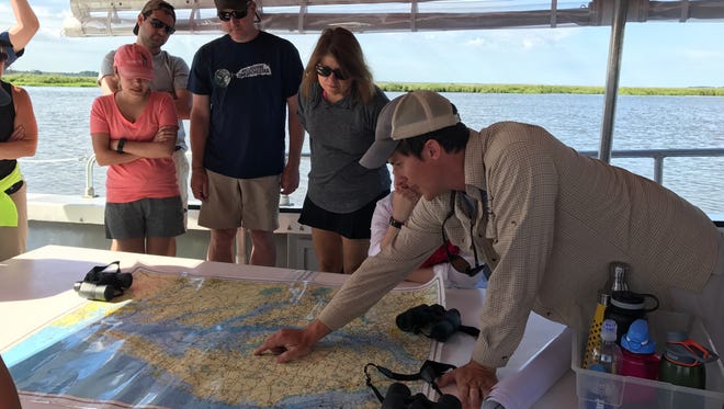 Adam Wickline (bottom right) shows a group of Wicomico County School District teachers the route they'll take on the Nanticoke River during its "Summer Institute" program on June, 27, 2017.