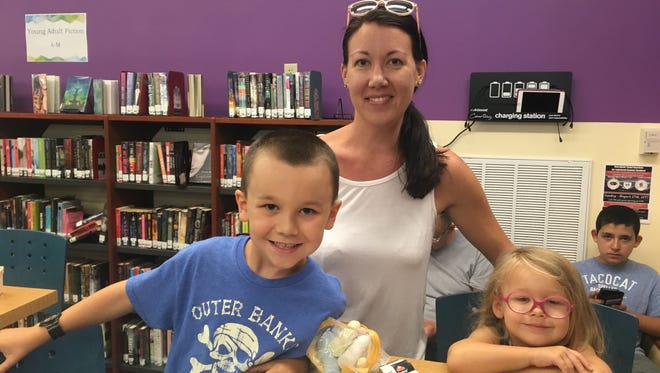 Melissa Face and her children, Evan, 6, and Delaney, 3, wait for the eclipse by doing crafts at the Worcester County Library in Ocean City on Monday, Aug. 21.