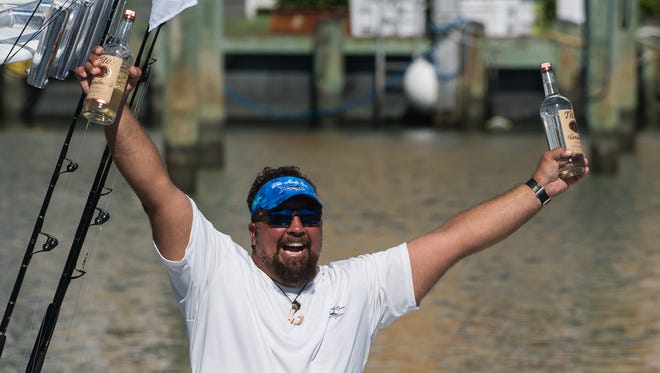 A member of Team Tito's celebrates upon arrival at Harbour Island Marina on Friday, Aug. 11, 2017.
