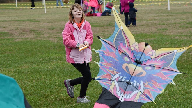 Alicia Hamilton from Millsboro flies her kite, Despite cloudy and rainy weather, the 48th Annual Kite Festival was held on Friday March 25th at Cape Henlopen State Park near Lewes with a good crowd on hand flying all kinds of kites and creations.