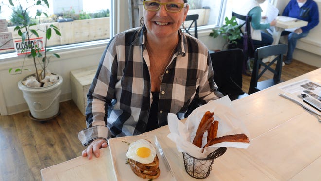 Missi Moore, Owner of Egg, with the Croque Madame- A classic ham & gruyere bechamel sandwich on housemate country bread topped with a sunnyside-up egg. Also, with a side of Sriracha bacon candy. Tuesday, Nov. 30, 2016.