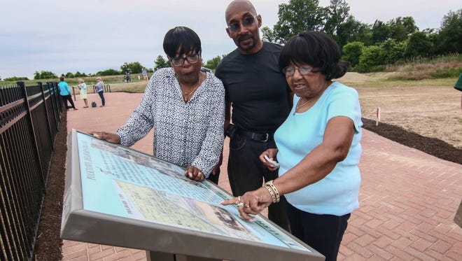 Joylette Carrington, right, the oldest resident of Polktown reminisces with her son and daughter Linda Price and Harry Portlock at Michael Castle Trail while visiting the African Union Church Cemetery near the trail, Wednesday, June 15, 2016, in Delaware City.