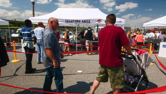 Customers wait in line at Jalapeno Grill tent at Saturday's Delaware Taco Festival at Frawley Stadium.