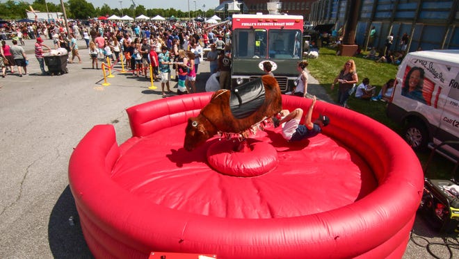 Austin Pitt of Maryland gets thrown from the mechanical bull at the Delaware Taco Festival Saturday, June. 25, 2016, at Frawley Stadium in Wilmington.