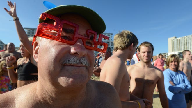 With his 2015 glasses on, Don O'Grince of Ocean City eyes the cold Atlantic Ocean shortly before he dove in during the AGH Penguin Swim Thursday afternoon in Ocean City.