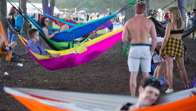 Festival goers relax in hammocks during the first day of live acts at Firefly Music Festival Thursday in Dover.