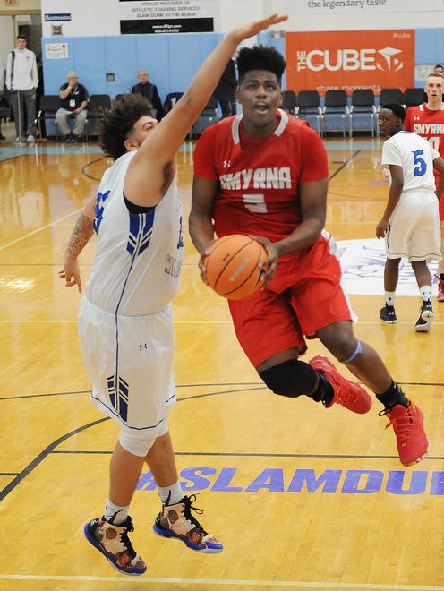 Smyrna's #5 Jaymeir Garnett was the high scorer as Smyrna High School (red) defeated Howard High School (white) 86-53 in the opening game of the Slam Dunk to the Beach Tournament held at Cape Henlopen High School on Wednesday December 27th. 
Special to the News Journal / CHUCK SNYDER