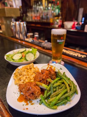 Twisted Soul's caramel wings with macaroni and cheese and green beans.