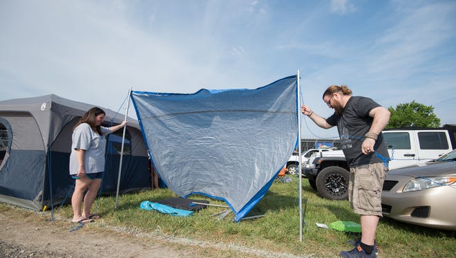 Michelle Cooper, left, and Troy Yarnall of Newark set up their tent in the camping area at the Firefly Music Festival in Dover.