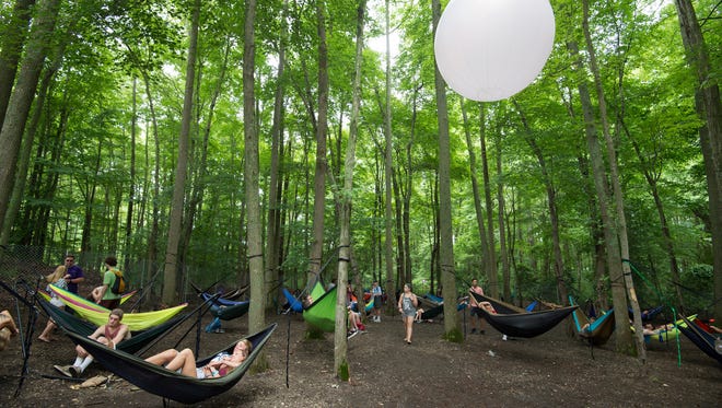 Festival goers take a break in the nook at the Firefly Music Festival in Dover.