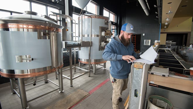 John Panasiewicz, head brewer, works on installing the new brewery equipment inside the new Iron Hill Brewery and Restaurant in Rehoboth that will be opening at the end of May.