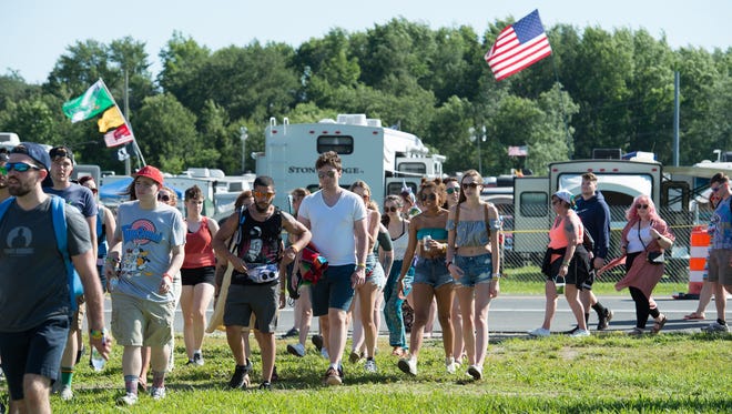 Festival goers pass through the gates on the opening day of the Firefly Music Festival in Dover.