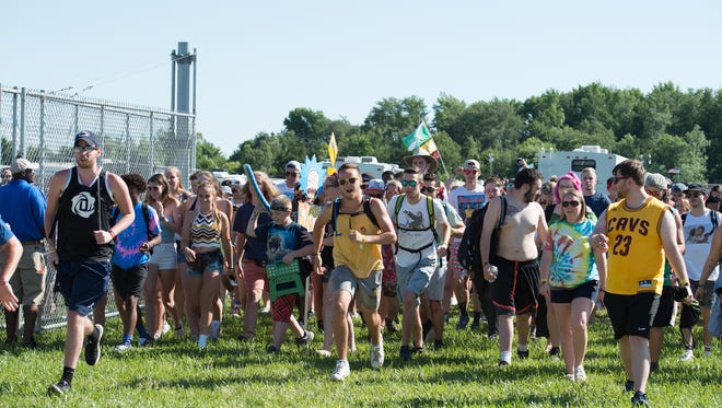Festival goers pass through the gates on the opening day of the Firefly Music Festival in Dover.
