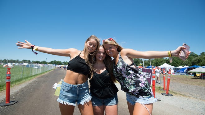 Madeline Hamer, left, of Charlottesville, Va., Nicole Verbits of Salisbury, Md., and Loryn Weer of Salisbury, Md., pose for a photo at the Firefly Music Festival in Dover.