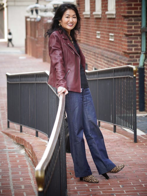 Pianist Hiroko Yamazaki wears blue Calvin Klein cotton/linen pants; black INC top; and a red Wilson leather jacket, a recent gift from her mom.
