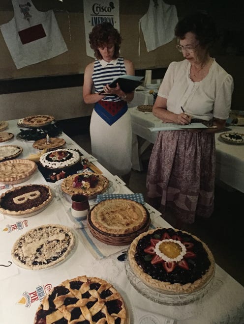 Kim Hoey (left) and Bulah Sockrider look over entries for the Crisco American Pie Celebration. See more vintage images of the Delaware State Fair.