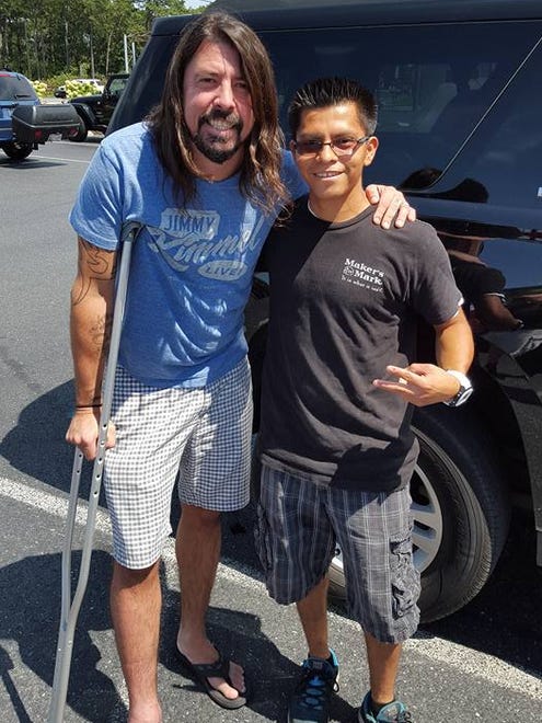 Foo Fighters' Dave Grohl  at Atlantic Liquors near Rehoboth Beach Sunday. He is pictured with fan and Atlantic employee Roberto Ruiz.