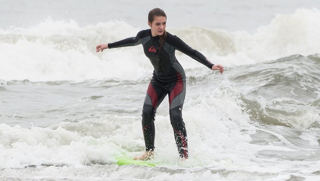 Amella Mehan rides a wave in Ocean City on Sunday, Oct. 15, 2017.