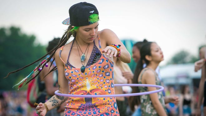 A woman dances around with her hula hoop during a performance by Banks at the Backyard Stage on day two of Firefly Music Festival Friday at The Woodlands in Dover.