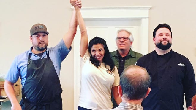 Festival organizer Stacy LaMotta declares Chef Doug Ruley of SoDel Concepts the winner of 2016 chef throwdown at the Southern Delaware Wine, Food and Music Festival  in Millsboro.