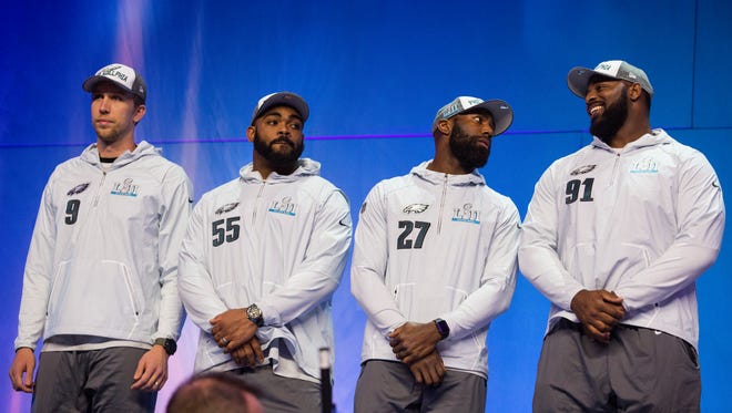 The Eagles' Nick Foles, 9, Brandon Graham, 55, Malcolm Jenkins, 27, and Fletcher Cox, 91, take the stage during the Super Bowl Opening Night Monday at the Xcel Energy Center.