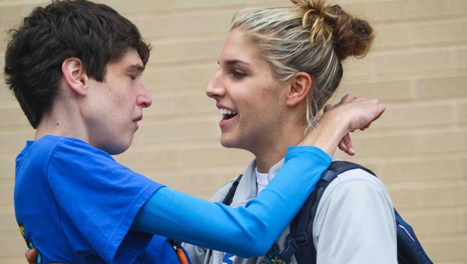 Elena Delle Donne gives her sister, Lizzie, a kiss and hug as the University of Delaware women's basketball team returns to the Bob Carpenter Center to cheering fans after their season ended in 2012 in the NCAA tournament.