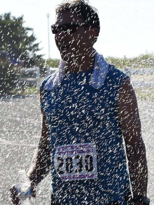 Paul Montini from Huntington Valley, PA cools off under a fire hose spray as Over 300 runners and walkers turned out for the 19th Annual Run for J.J. 5K & 5K Walk held on Sunday July 24th in downtown Rehoboth Beach.