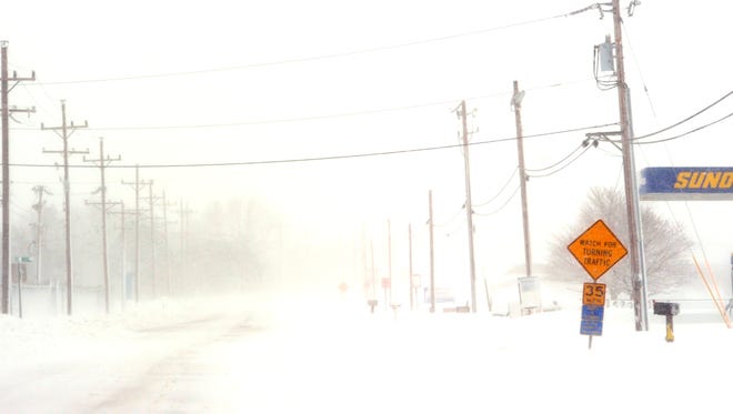 Gusty winds blowing snow across Rt. 14 in Milford.