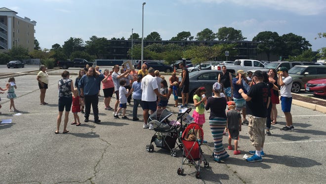 A crowd of about 20 people gathered in the Worcester County Library parking lot to view the eclipse in Ocean City on Monday, Aug. 21.