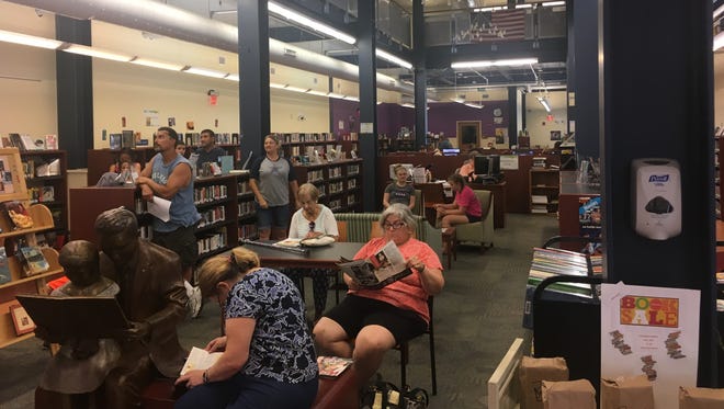 A crowd waits inside the Worcester County Library in Ocean City on Monday, Aug. 21.