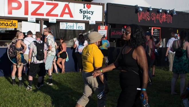 Festival goers ease their way into the first day of live music at Firefly Music Festival Thursday in Dover.
