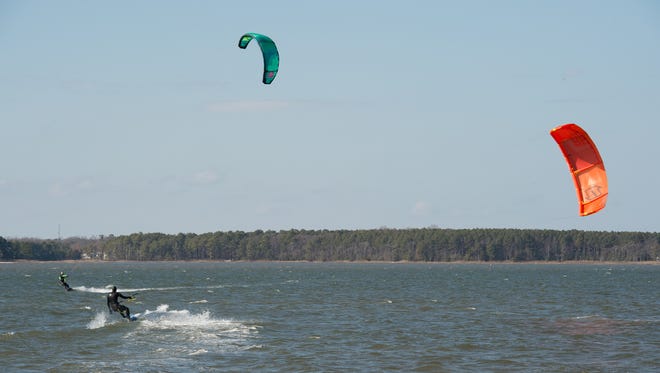 Sean Colgan, left, of Rehoboth, owner of Got Wind? kiteboarding school and Jess Dodd of Bethany Beach enjoy a afternoon of kiteboarding in the Rehoboth Bay south of Dewey Beach.