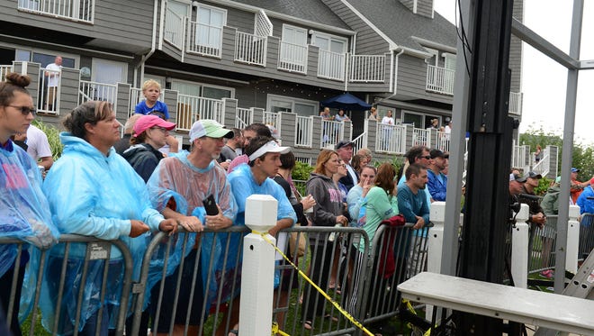 Spectators line up in rain gear on the first day of The White Marlin Open at Harbour Island Marina in Ocean City, Md. on Monday, August 7, 2017.