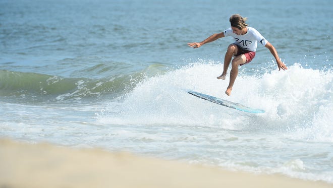 John Weber, Dana Point, Ca, spins his board 360 degrees during the Men's Pro Division heat in the semifinals of the Skim USA Association ZAP Pro/Am Skimboarding Competition in Dewey Beach, De. on Friday, August 11, 2017.