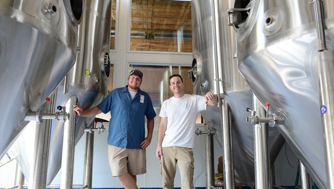 Big Oyster Brewing's Mike Anderson, Sales & Distribution and Andrew Harton, Head Brewer, pose in the new home of Big Oyster Brewing on Tuesday, August 22, 2017.