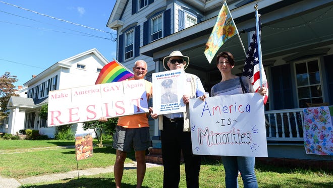 Charlie Mead-e, Toby Perkins and Shelly Copper made signs to voice their opinion against the "Support Our President" rally in Georgetown on Saturday, Sept. 9, 2017.