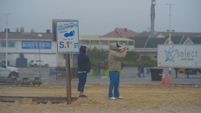 People take photos of the rough surf in Ocean City, Md. as Hurricane Maria is off the coast in the Atlantic Ocean on Wednesday, Sept. 27, 2017.
