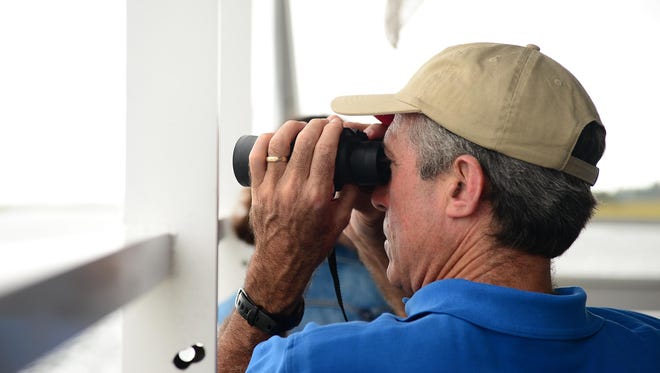 Gov. John Carney looks at local wildlife from aboard the Cape Water Taxi down the Lewes Canal on Wednesday, Sept. 27, 2017.